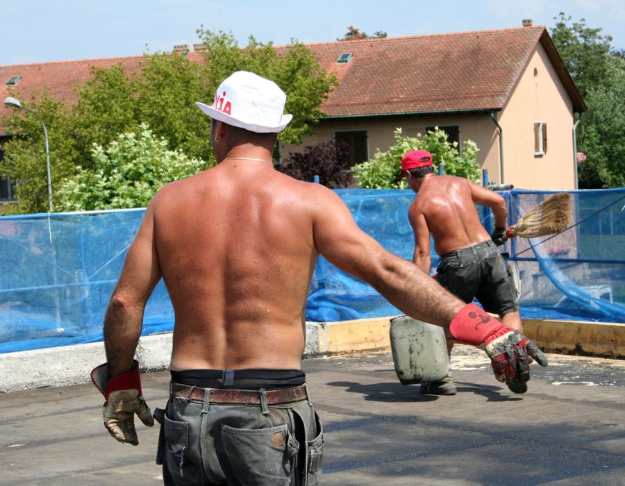 Ouvriers torse nu sur un chantier en plein soleil.