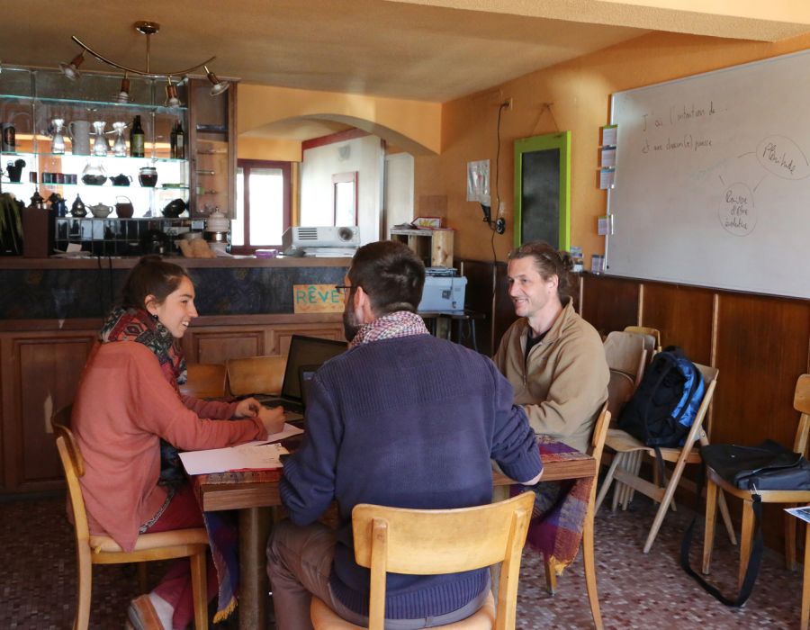 Les trois membres des artisans du lien, Charlène Goulinet, Marc Mariéthoz (de dos) et Alain Maret en réunion dans leur local de Bramois.